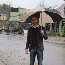 Alex trying to shelter himself from the rain falling in Los Olivos