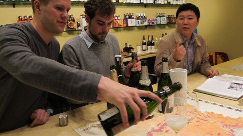 Tim O'Rourke (at right) watching as one of the staff pours some wine.